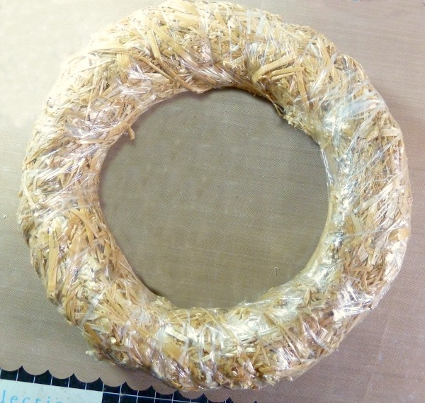 Plastic wrapped straw wreath form as guide for Egg and Ribbon wreath Photo of plastic wrapped straw wreath