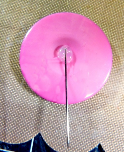 Straight pin glued to back of button
