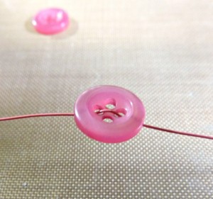Threading wire through button