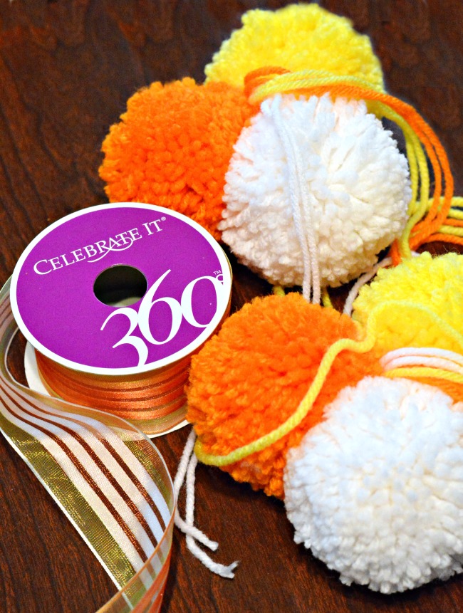 Bright, fluffy and Halloween-happy, Candy Corn Pompom Wreaths are candy-inspired holiday decor for doors or windows! At littlemisscelebration.com #crafts #halloween