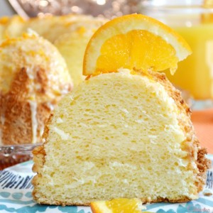 Bake up a light-as-air & delicious Orange Sponge Cake, finished with bright, orange glaze & grated orange peel. Perfect for a celebration! at littlemisscelebration.com