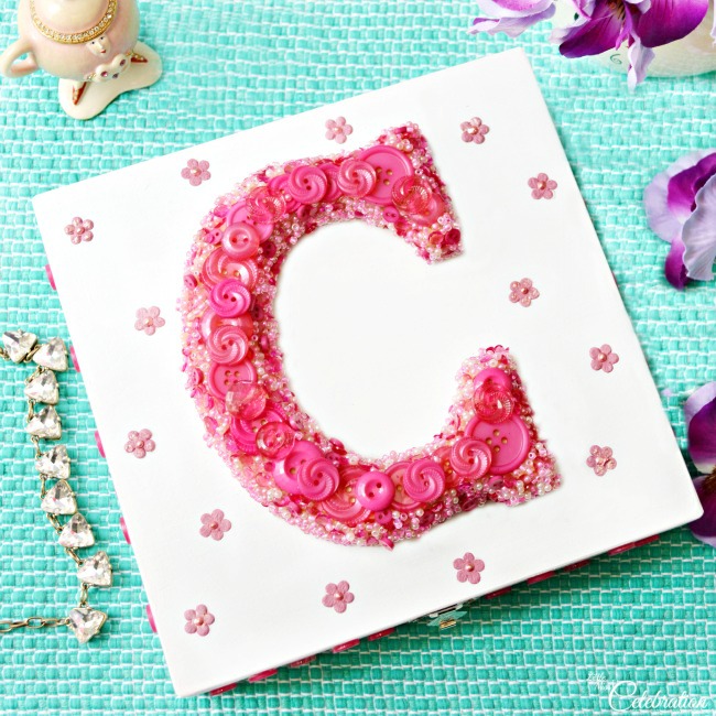 A DIY Buttoned & Beaded Monogrammed Jewelry Box makes a pretty gift for Mom & every special lady in your life! Add a piece of jewelry inside and it's a double gift! At littlemisscelebration.com