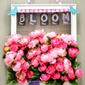 An old frame gets a fresh coat of white paint and is backed with floral mesh to hold masses of gorgeous silk, pink peonies for this Bursting with Blooms Door Wreath! at littlemisscelebration.com