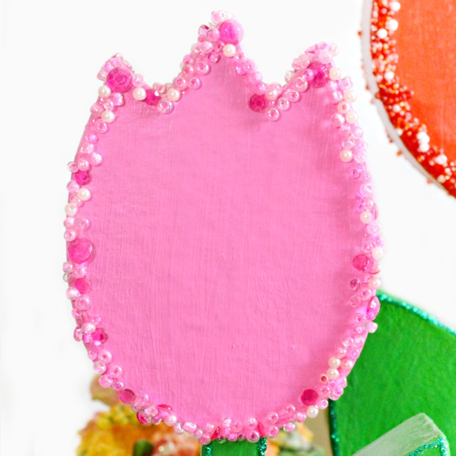 How CUTE are these forever tulips? It's easy to turn paper mache flowers into bright, sparkling charmers perfect for Mother's Day! at littlemisscelebration.com