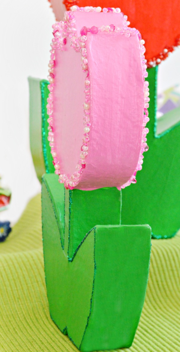 How CUTE are these forever tulips? It's easy to turn paper mache flowers into bright, sparkling charmers perfect for Mother's Day! at littlemisscelebration.com