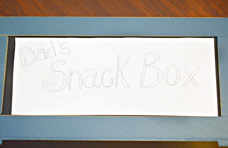 A small wooden crate that’s pre-painted with a chalkboard front makes it a snap to put together this Easy Snack Crate for Dad! Fill with his favorite munchies! at littlemisscelebration.com